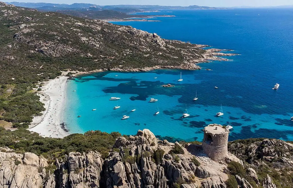 Roccapina Bay in Corsica, aerial view of turquoise anchorage and Genoese tower