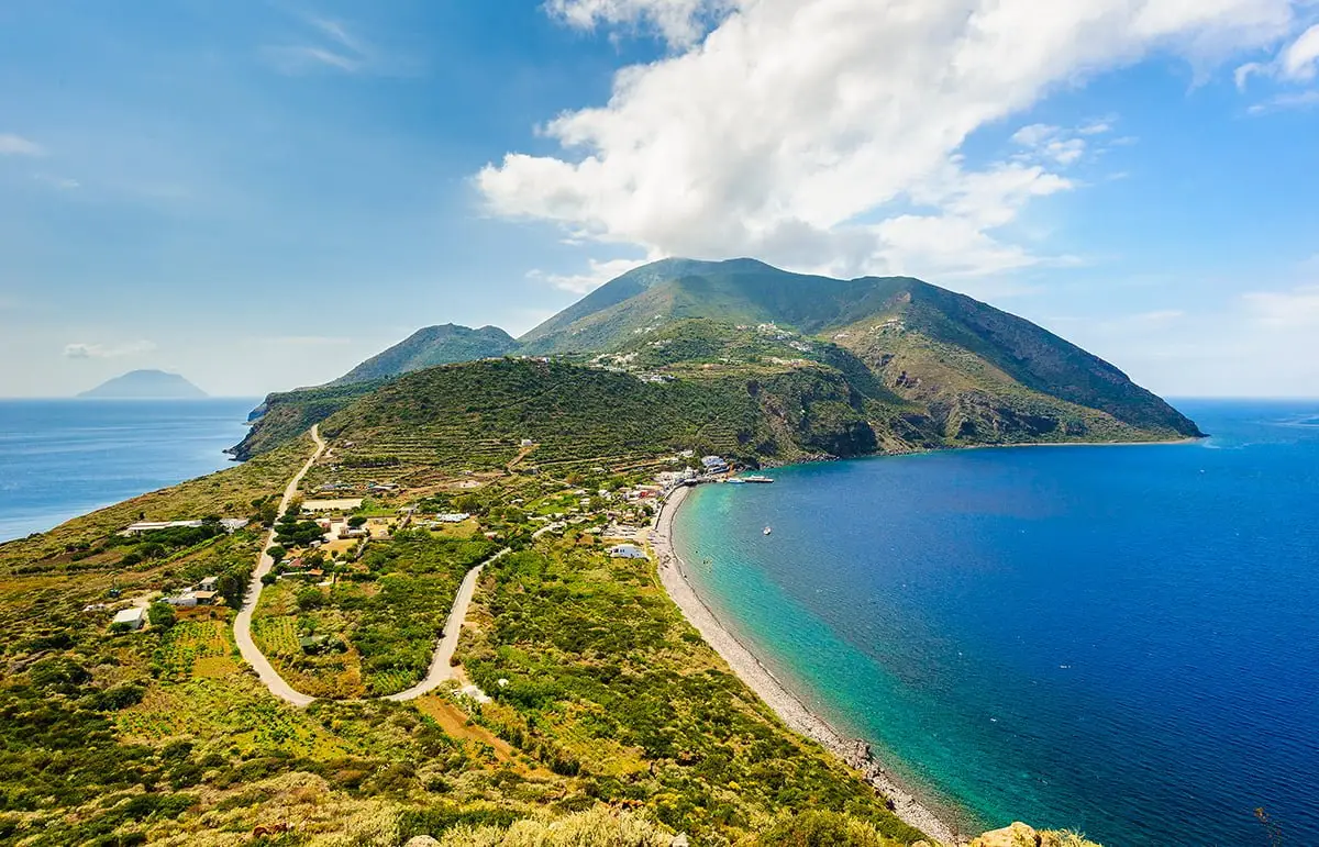 Filicudi Island coastline with lush hills and clear waters, Aeolian Islands, Italy
