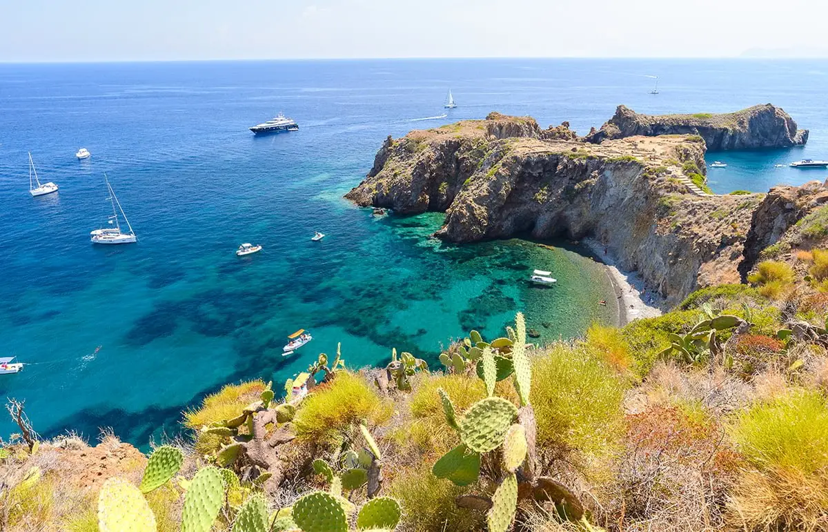 Panarea island cove with yachts anchored in turquoise waters, Aeolian Islands
