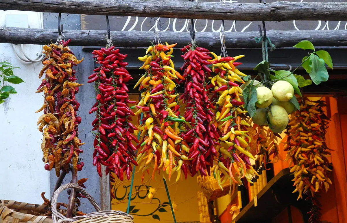 Capri market with hanging chili peppers and Mediterranean produce