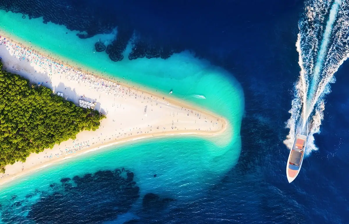 Zlatni Rat Beach, Brač Island – Aerial View of Croatia’s Famous Golden Cape with Yacht Cruising Nearby