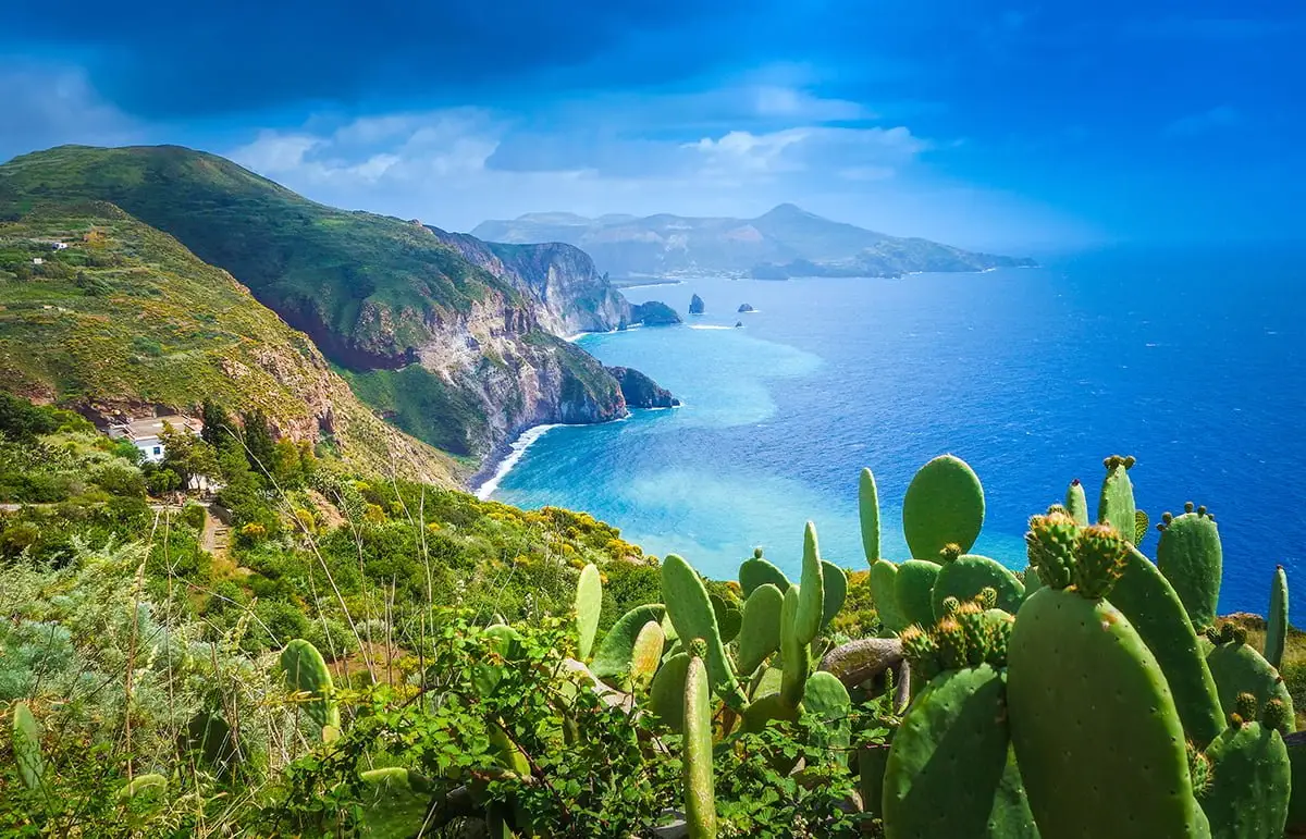 Scenic coastal view of Lipari Island with lush cliffs and turquoise sea, Aeolian Islands