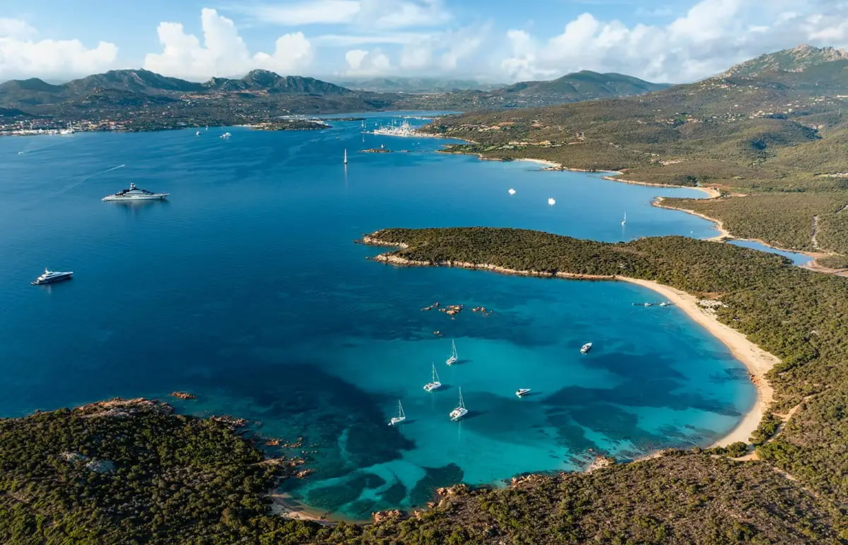 Aerial view of Cala di Volpe Bay with yachts anchored in Costa Smeralda, Sardinia