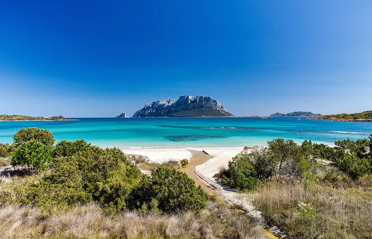 Sardinia’s Porto Istana beach with turquoise sea and island view
