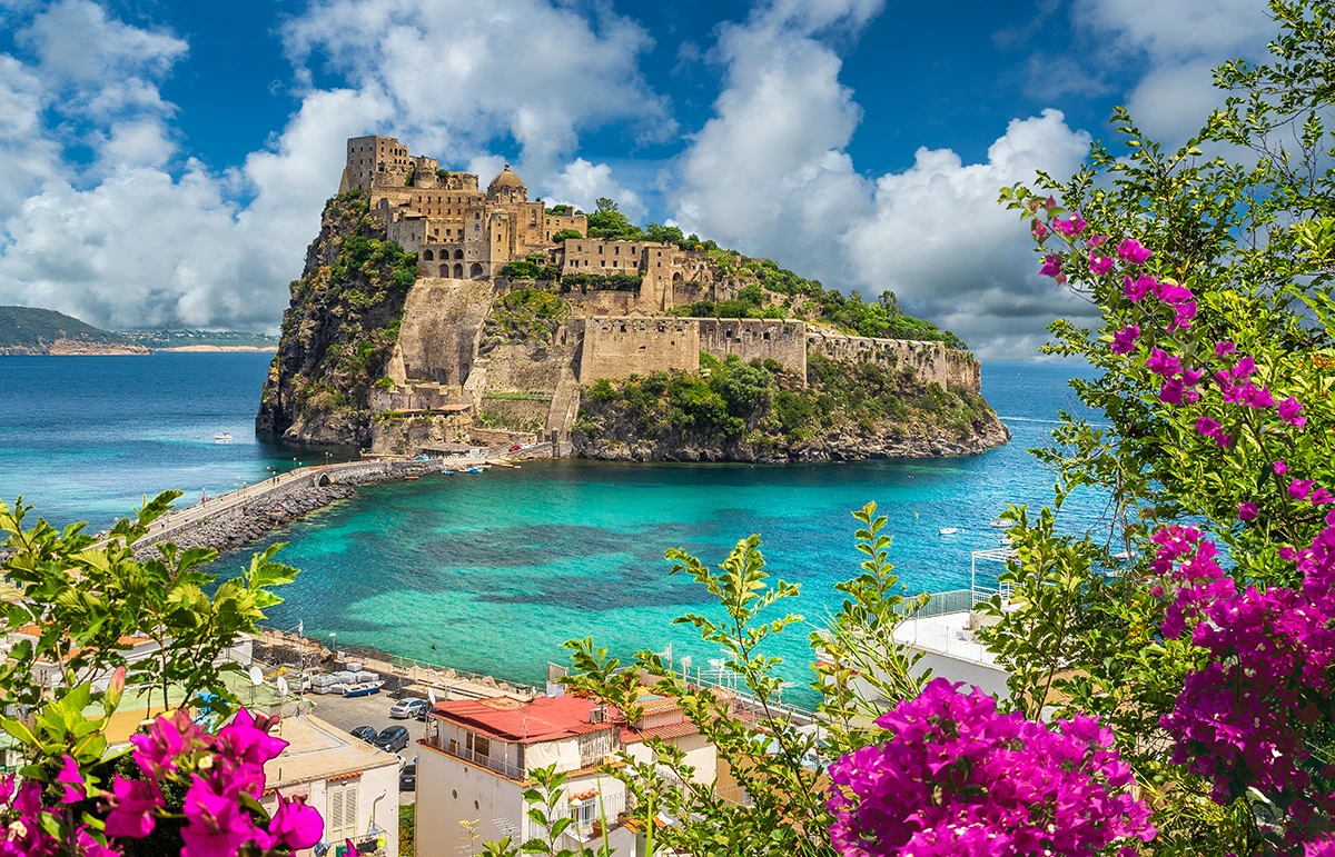 Aragonese Castle on Ischia Island with turquoise waters and flowers
