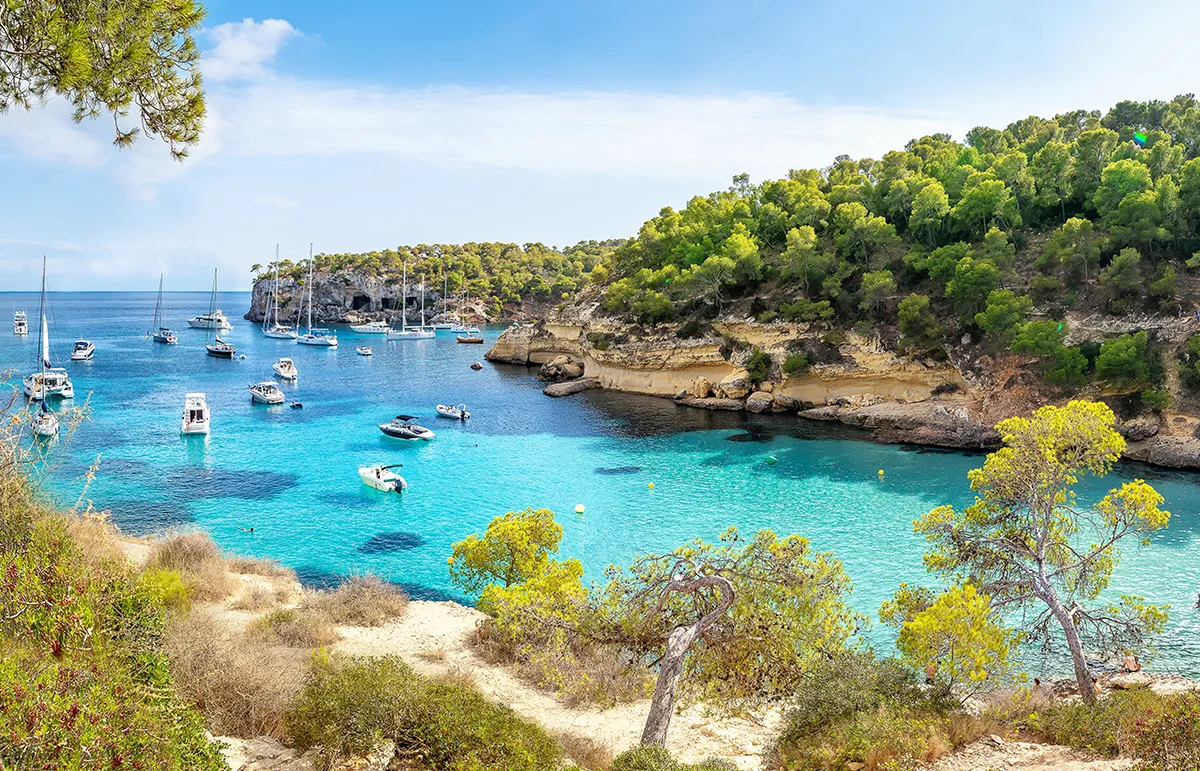 Mallorca yacht charter bay anchorage boats turquoise water Balearic Islands Spain