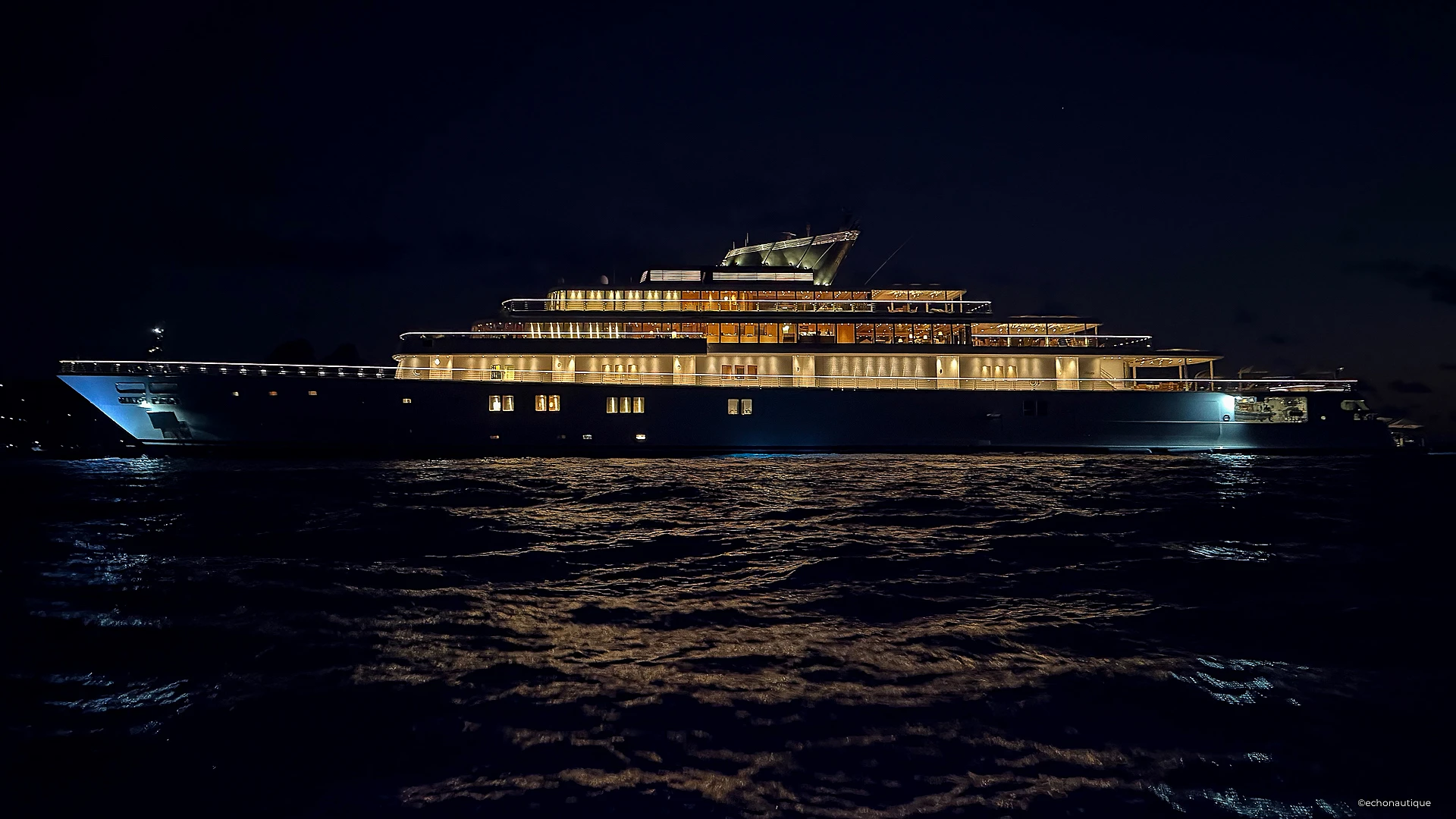 Superyacht RISING SUN 138m by Lürssen illuminated at night in St Barths during New Year’s Eve