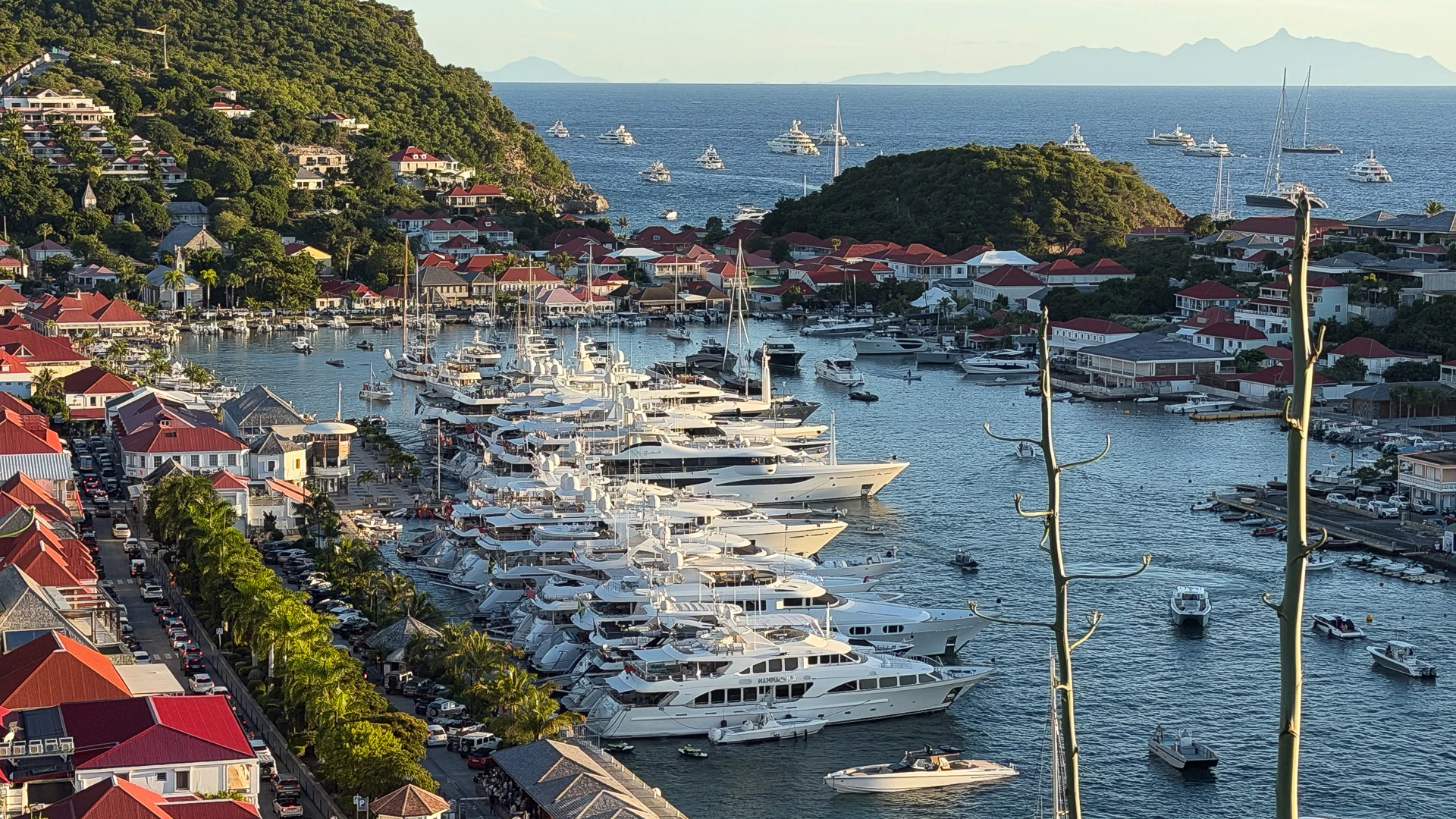 St Barths superyachts gathered in Gustavia Bay at sunset for New Year’s Eve 2025, the world’s largest superyacht event