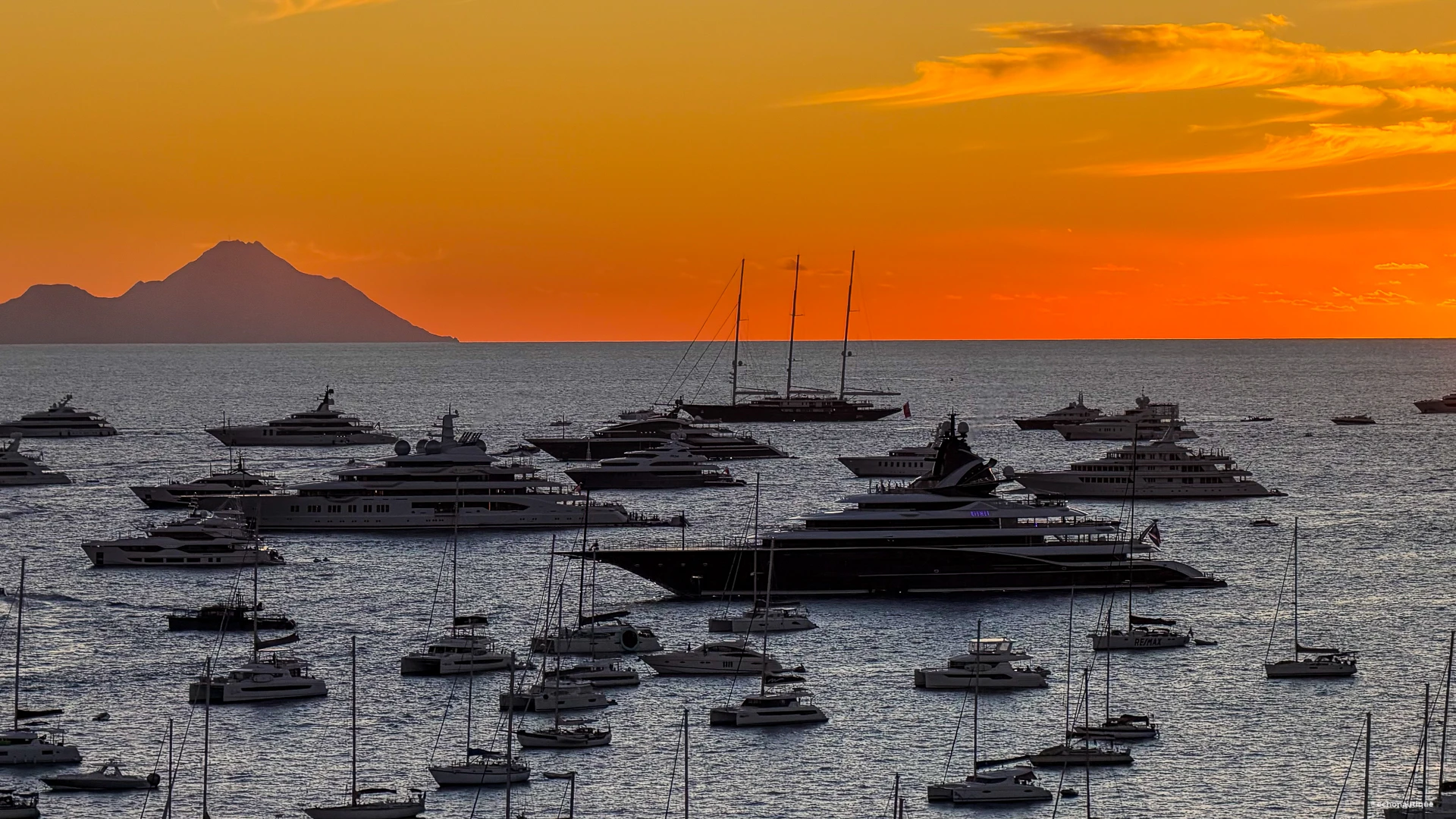 Superyachts anchored in Gustavia Bay at sunset on New Year’s Eve 2025 in St Barths