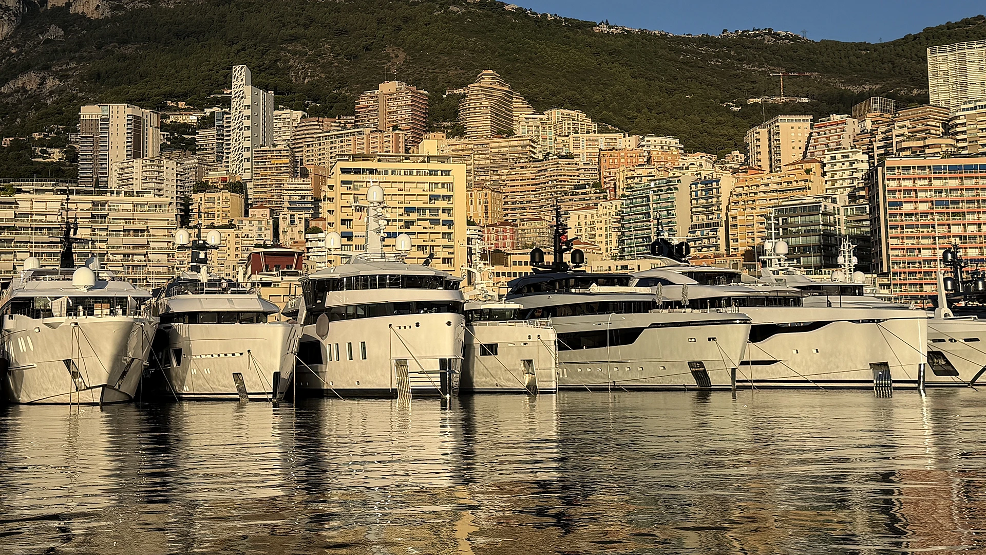 Superyachts moored in Monaco illustrating cross-border yacht charter APA management and multi-jurisdiction operations
