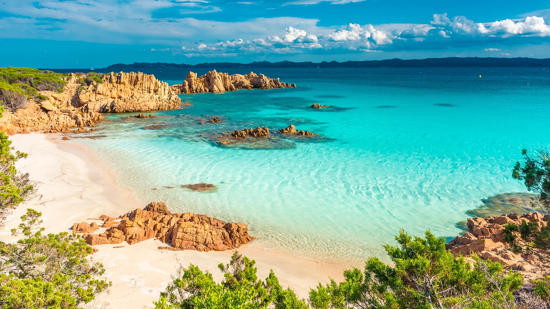 Turquoise waters and granite rocks of La Maddalena Archipelago, a highlight of a Sardinia yacht charter itinerary