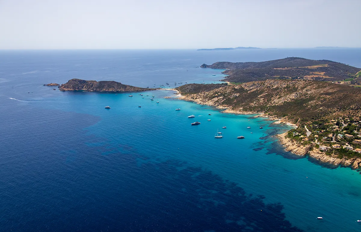 Aerial view of L'Escalet and Cap Taillat near St Tropez with luxury yachts anchored in turquoise Mediterranean waters. - Echonautique.com L'Escalet and Cap Taillat | Crystal Clear Waters Near St Tropez