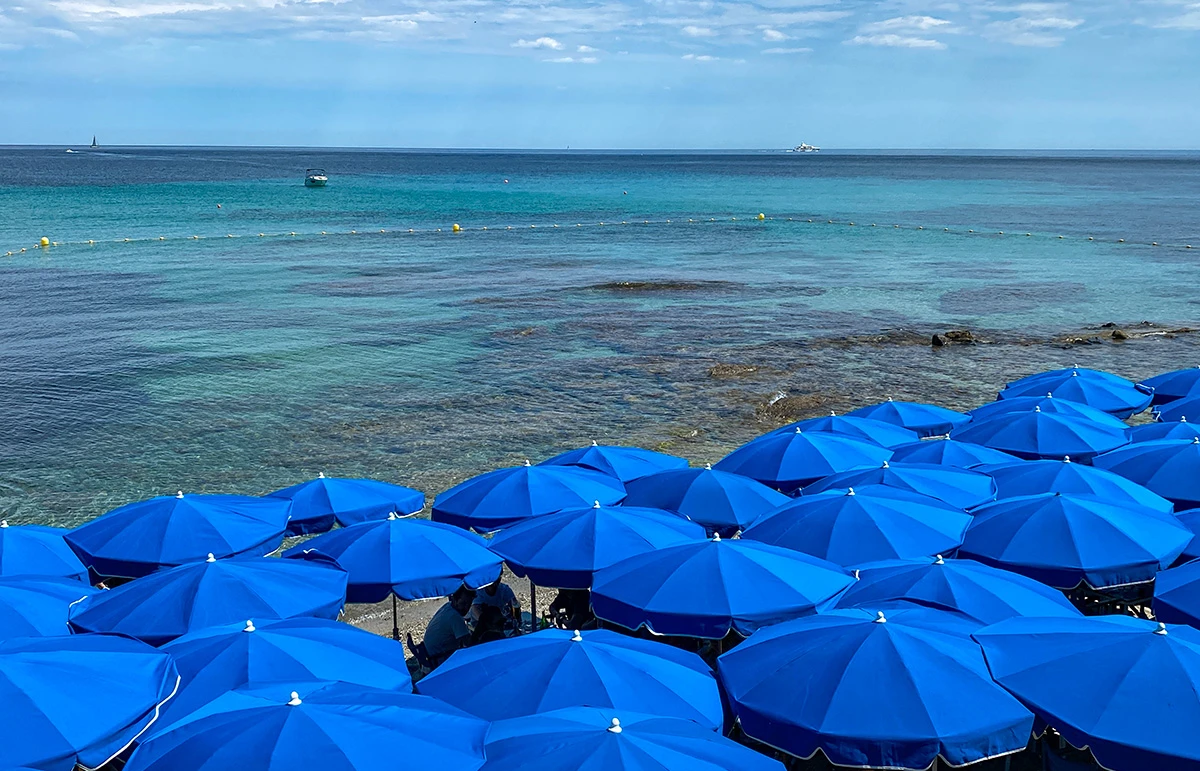 Blue umbrellas on Plage des Salins beach near Saint Tropez