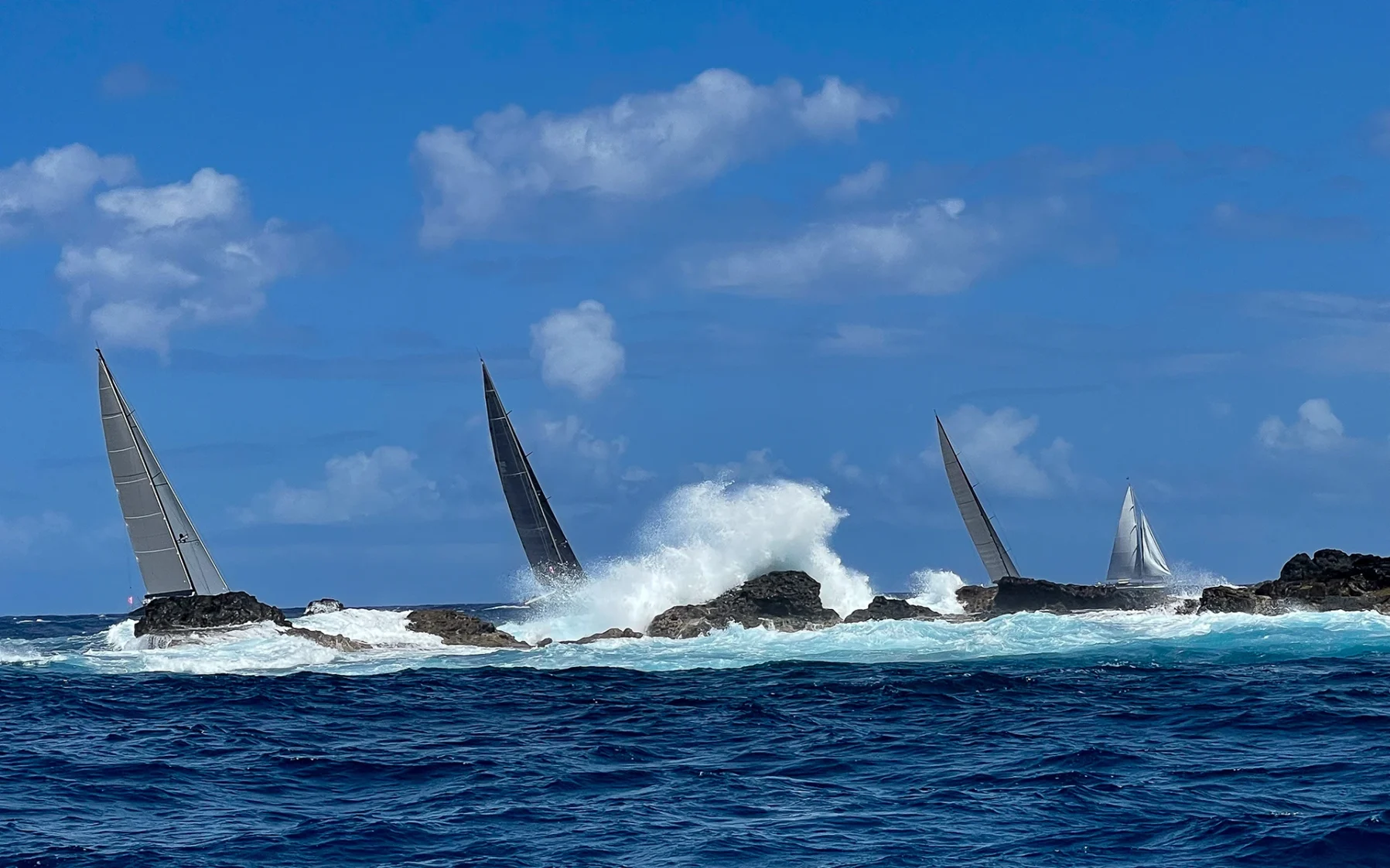 Sailing superyachts racing during the St Barths Bucket Regatta near Gustavia