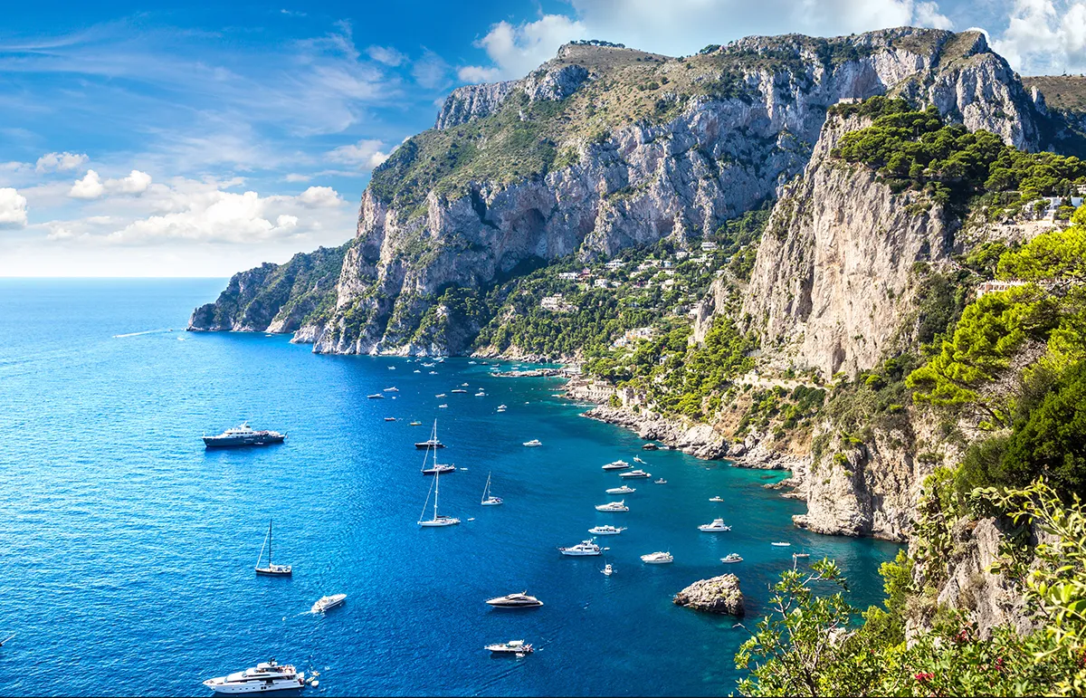 Capri Island Amalfi Coast Yacht Charter - Echonautique.com Luxury yachts anchored off Capri Island during an Amalfi Coast yacht charter in Italy