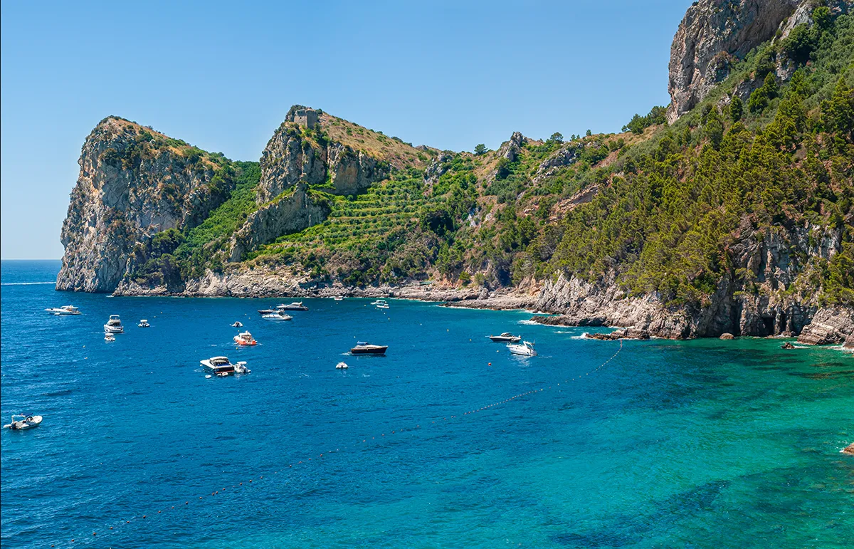 Nerano Bay Amalfi Coast Yacht Charter - Echonautique.com Luxury yachts anchored in Nerano Bay during an Amalfi Coast yacht charter in Italy