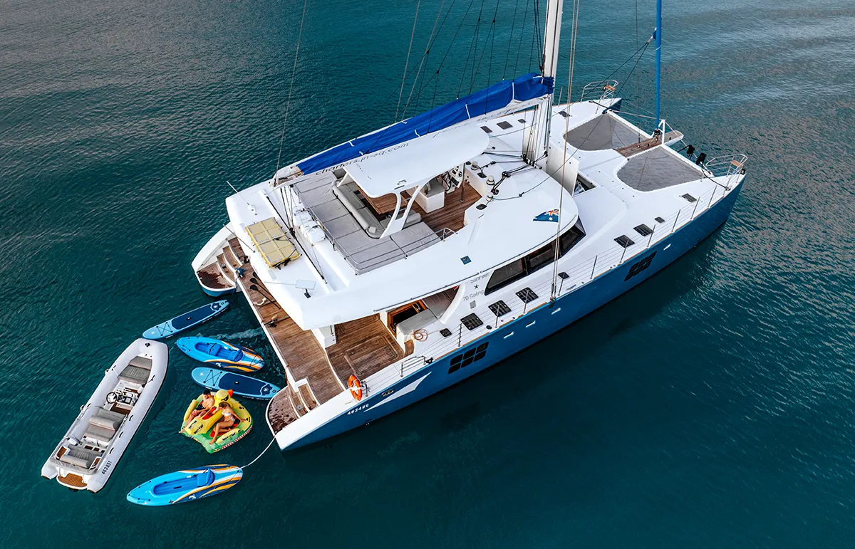 FENG Sunreef 70 yacht charter aerial view luxury catamaran at anchor turquoise water Mediterranean