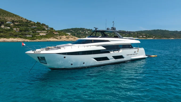 Ferretti yacht side view on turquoise water